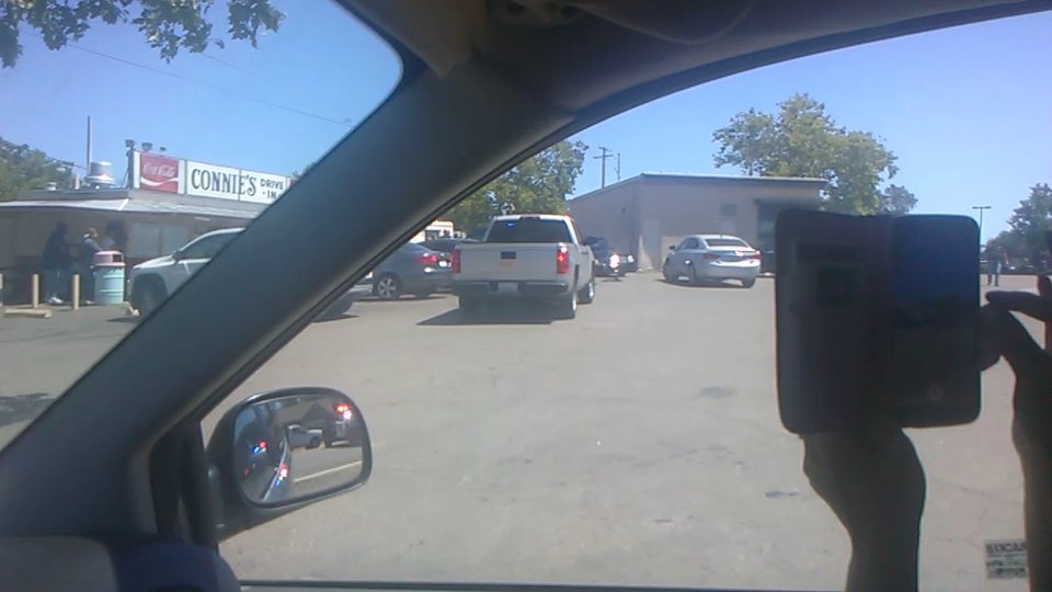 Drive-in restaurant exterior with parking nearby.